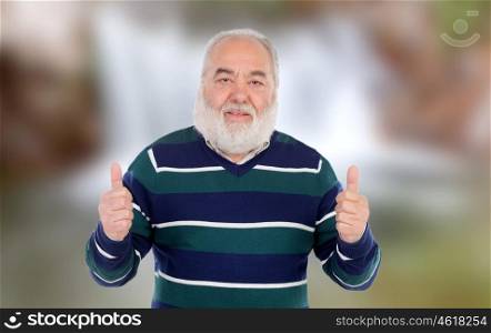 Senior man saying Ok on a unfocused background