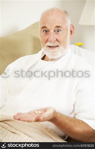 Senior man sick in bed doesn&rsquo;t want to take his medicine.