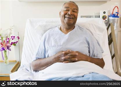 Senior Man Sitting In Hospital Bed,Smiling