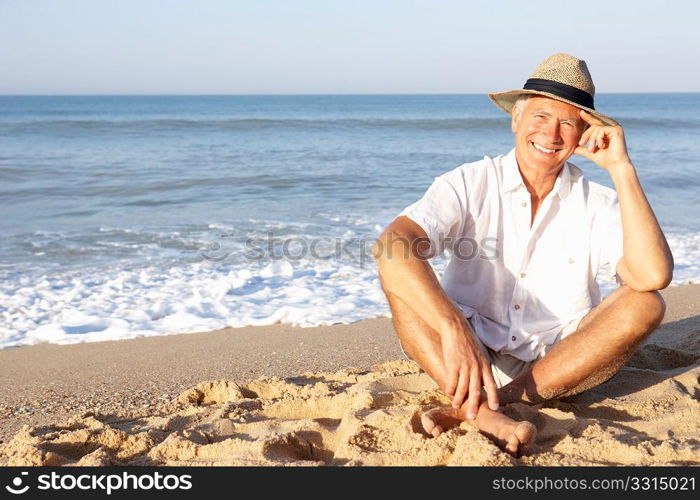 Senior man sitting on beach relaxing