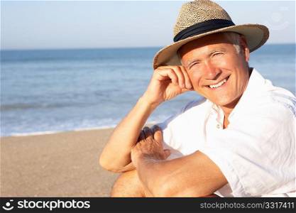 Senior man sitting on beach relaxing