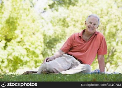 Senior man sitting outdoors