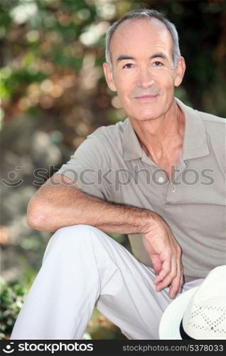 Senior man sitting outdoors