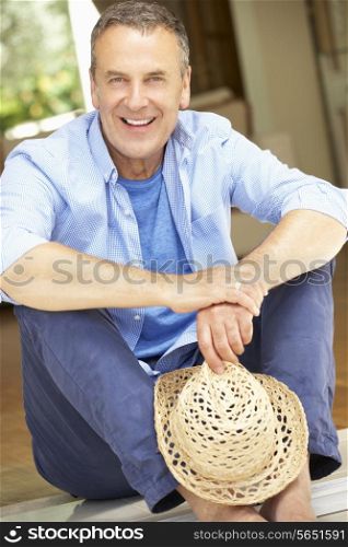 Senior Man Sitting Outside House