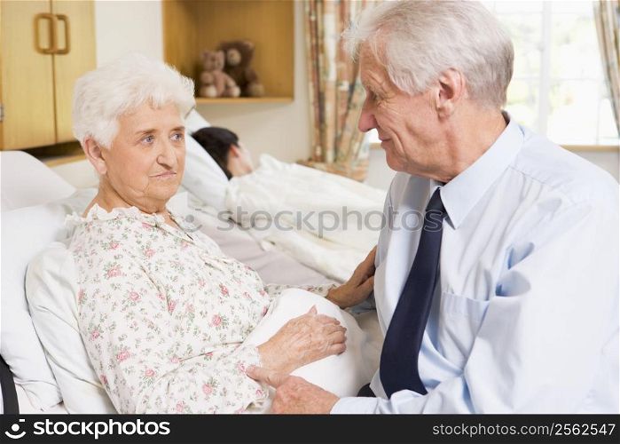 Senior Man Sitting With His Wife In Hospital