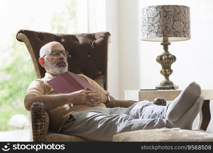 senior man sleeping while reading a book