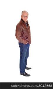 Senior man standing in a brown leather jacket and jeans isolatedfor white background with his hands in his pocket.