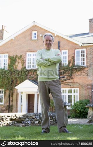 Senior Man Standing Outside House