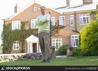 Senior Man Standing Outside House