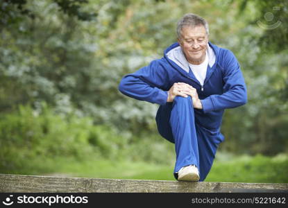 Senior Man Stretching On Countryside Run