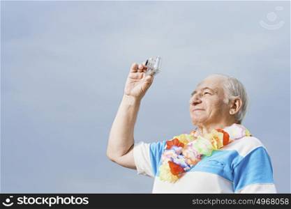 Senior man taking a photograph