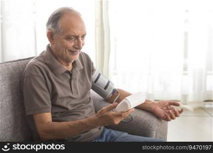 Senior man taking his blood pressure test at home.  Health and fitness  