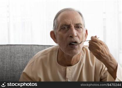 Senior man taking his medicines.  Health and fitness  