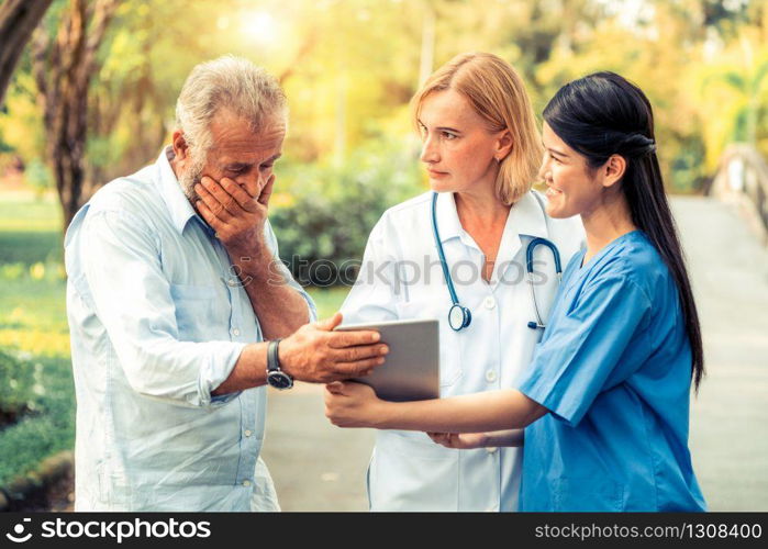 Senior man talking to doctor, nurse or caregiver in the park. Mature people healthcare and medical staff service concept.. Senior couple talking to nurse or caregiver.