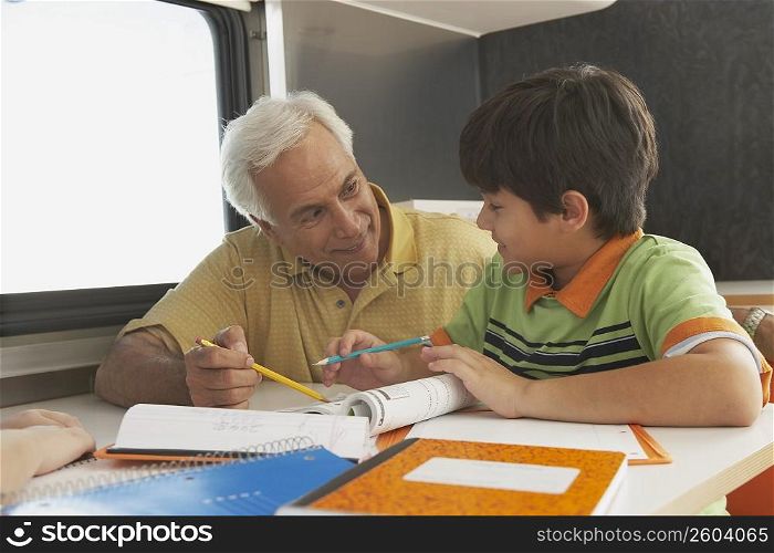 Senior man teaching his grandson