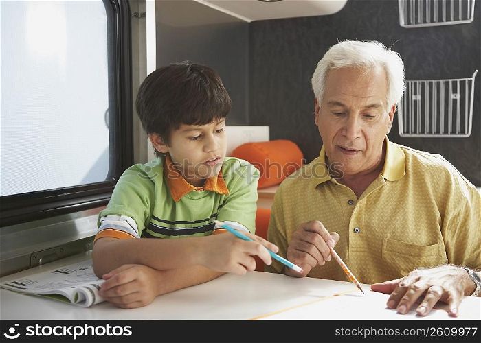 Senior man teaching his grandson