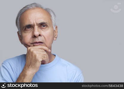 Senior man thinking with hand on chin