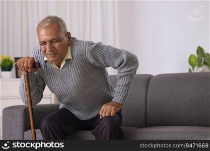 Senior man trying to stand alone with the help of walking stick