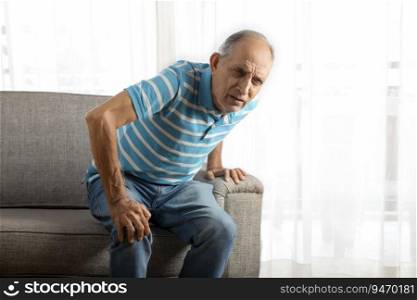 Senior man trying to stand up with a knee pain.  Health and fitness   