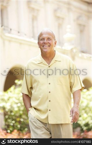 Senior Man Walking Through City Street