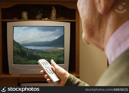 Senior man watching television