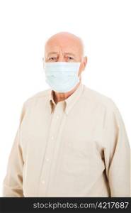 Senior man wearing a surgical mask to protect against flu epidemic. Isolated on white.
