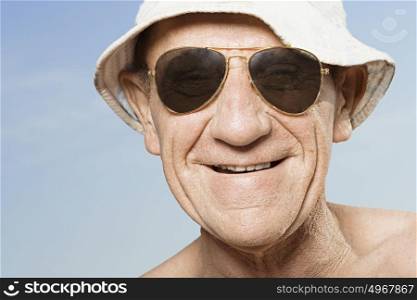 Senior man wearing sunhat and sunglasses