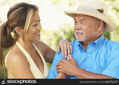 Senior Man With Adult Daughter In Garden