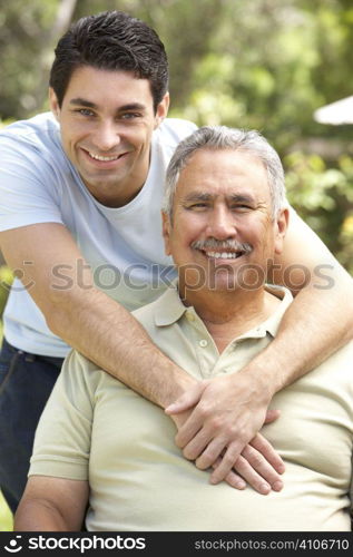 Senior Man With Adult Son In Garden