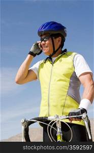 Senior man with bike talking on cell phone