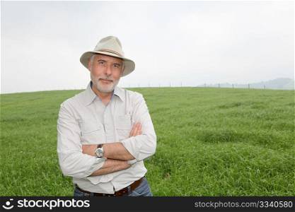 Senior man with hat in farmland