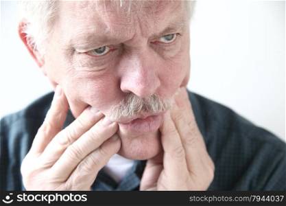 senior man with pain in his teeth or cheeks