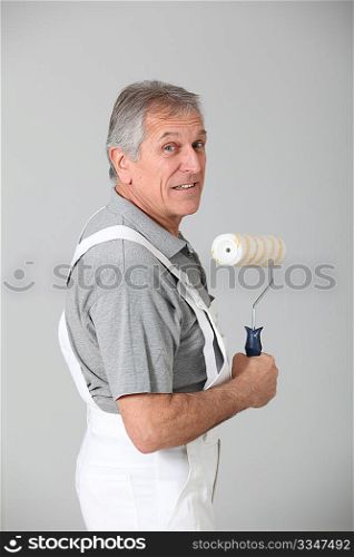 Senior man with paint roll