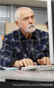 senior man working on computer at home