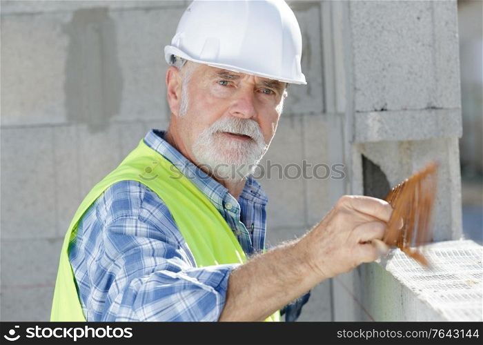 senior man working on indoor structure