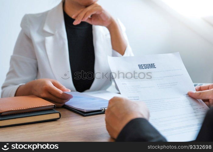 Senior manager HR reading a resume during a job interview employee young man meeting Applicant and recruitment