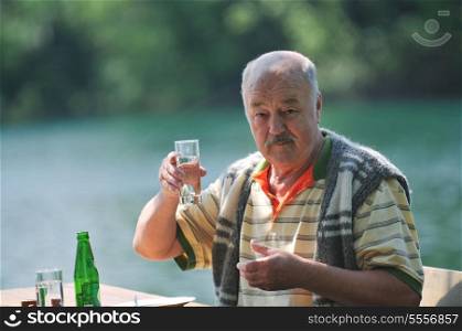 senior mature man eat sweet food at beautiful outdoor restaurant