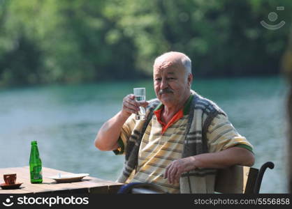 senior mature man eat sweet food at beautiful outdoor restaurant