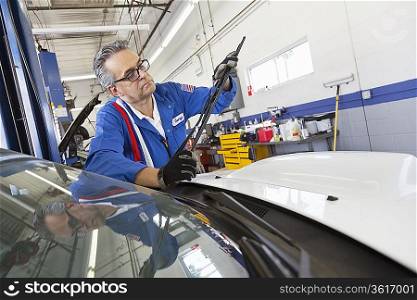 Senior mechanic working on windshield wipers