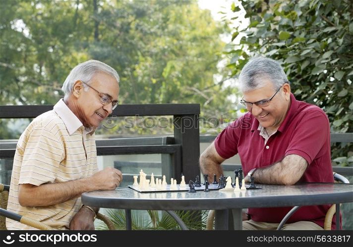 Senior men playing chess in leisure time