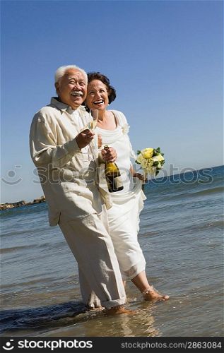 Senior Newlyweds Walking in Ocean