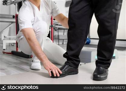 Senior Patient and physical therapist in rehabilitation walking exercises. High quality photo. Senior Patient and physical therapist in rehabilitation walking exercises.