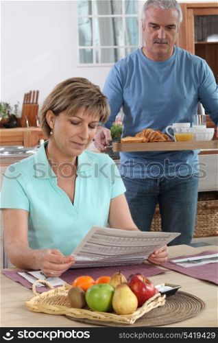 senior preparing breakfast for his wife