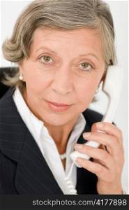 Senior professional businesswoman on phone close-up portrait