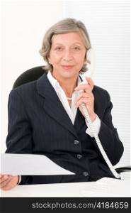 Senior professional businesswoman on phone hold empty sheet