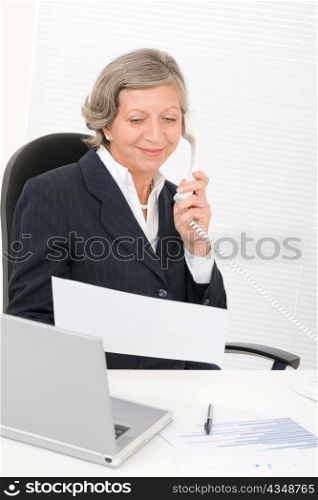 Senior professional businesswoman on phone hold empty sheet smiling