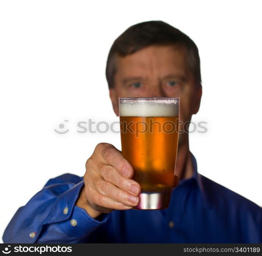 Senior retired male with a cool glass of beer with the man out of focus