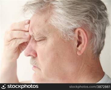 Senior suffering from a bad headache centered near his eye