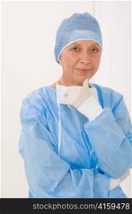 Senior surgeon female in protective operation overall uniform and mask