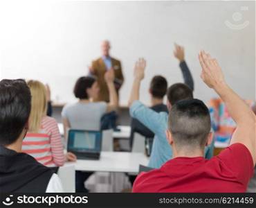 senior teacher teaching lessons, smart students group raise hands up in school classroom on class
